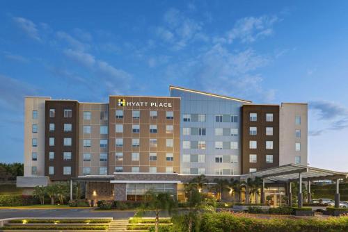 a hotel building with a night palace sign on it at Hyatt Place Managua in Managua