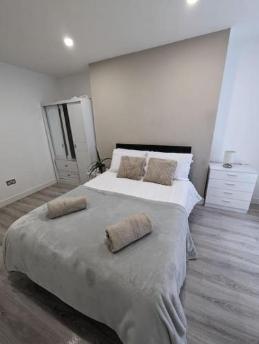 a bedroom with a large bed with two pillows on it at Bold street apartment in Liverpool