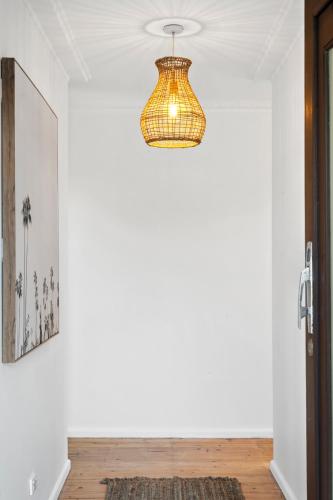 a hallway with a chandelier hanging from a ceiling at Nature's Edge Hideaway in Ocean Grove