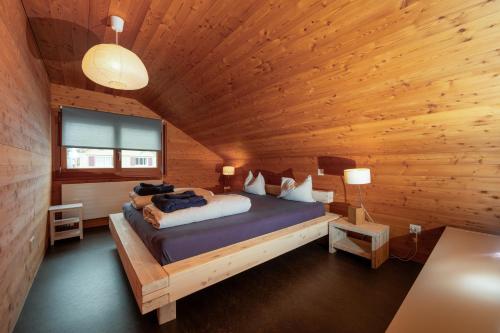 a bedroom with a bed in a wooden cabin at UnderDach in Andermatt