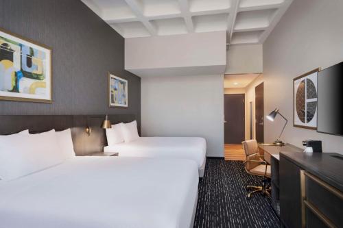 a hotel room with two beds and a desk at Hyatt Place LAX/Century BLVD in Los Angeles