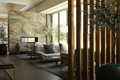 a living room with a couch and a fireplace at Hyatt Place LAX/Century BLVD in Los Angeles