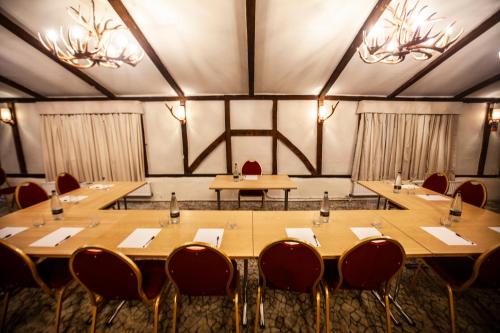 a conference room with tables and chairs and lights at Best Western Brome Grange Hotel in Brome