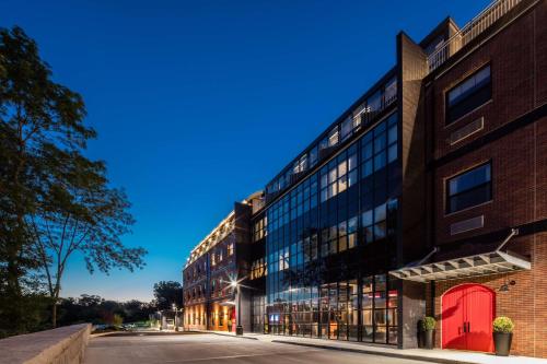 an office building with a red door on a street at Hotel Nyack, a JdV by Hyatt Hotel in Nyack