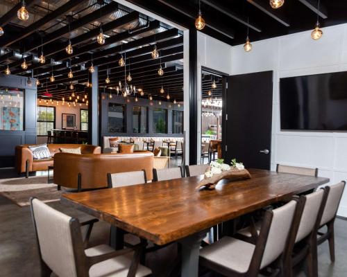 a dining room with a wooden table and chairs at Hotel Nyack, a JdV by Hyatt Hotel in Nyack