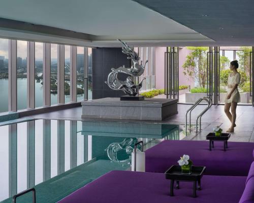 a rendering of a hotel lobby with a swimming pool at Hyatt Centric Lakeside Ningbo in Ningbo