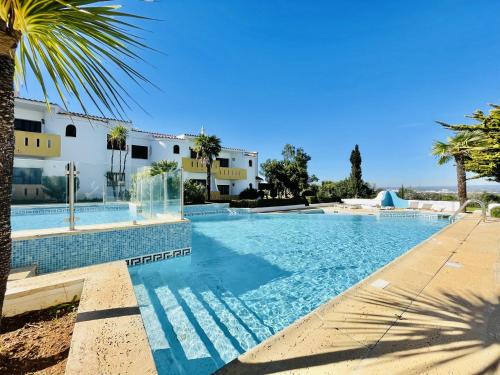 a swimming pool in front of a villa at Lavanda - 2 Bedrooms - 3 Level Pool - Garden - Beach 1km in Estômbar