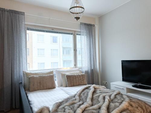 a bedroom with a bed with a large window at Aurora City Suite in Rovaniemi