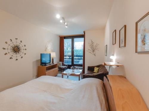 a bedroom with a bed and a living room at Apartment Sun & Mountain View by Interhome in Bad Hofgastein