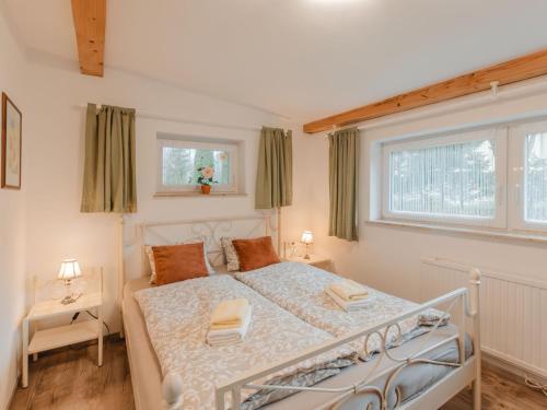 a bedroom with a white bed and a window at Holiday Home Ferienhaus Keil by Interhome in Bad Gastein