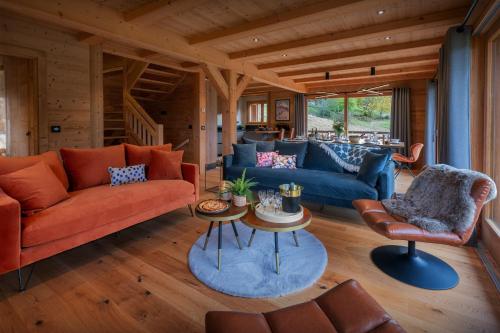a living room with couches and tables in a house at Chalet Q - OVO Network in Châtel