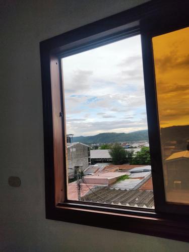 a window with a view of a city at Este Hotel in Estelí