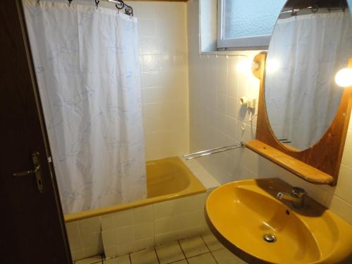 baño con lavabo y cortina de ducha en Sonnige Etagenwohnung im Waldgebiet, en Schortens