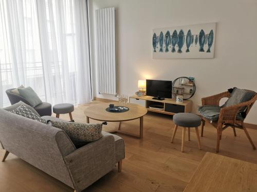 a living room with a couch and a table at Apartment Villa Terre neuve by Interhome in Saint Malo