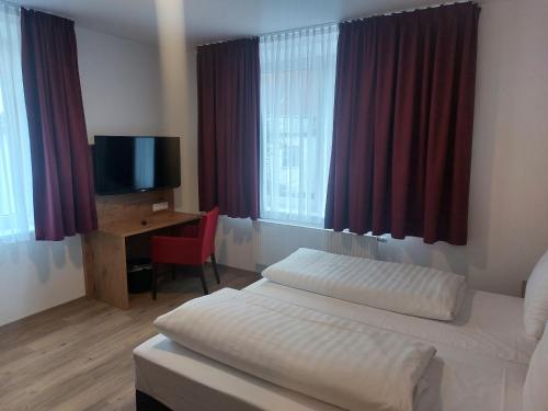 Postel nebo postele na pokoji v ubytování Hotel Stern