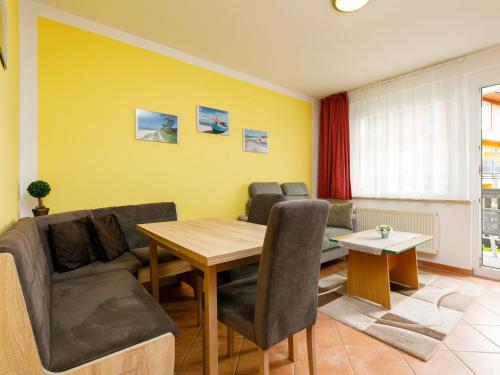 a living room with a couch and a table at Apartment Dünenhaus App- 104 by Interhome in Zempin