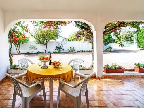 a table with a bowl of fruit on it in a patio at Apartment Quinta Girassol-5 by Interhome in Loulé