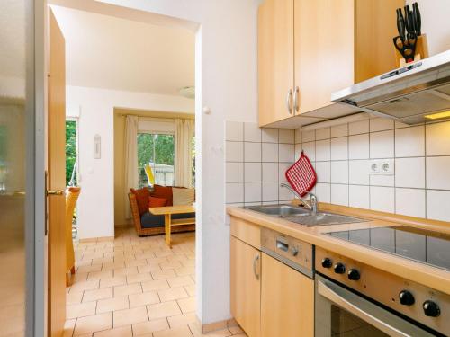 a kitchen with a sink and a stove at Holiday Home Im Kiefernweg DHH 21 by Interhome in Zinnowitz