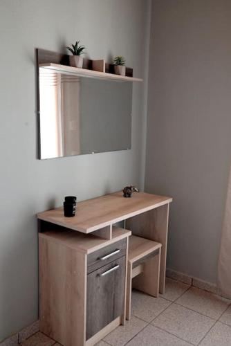 a dressing table with a mirror and some plants at Villa Magda in Syvota