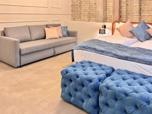 a living room with two beds and a couch at Bazaar Boutique Residence in Budapest