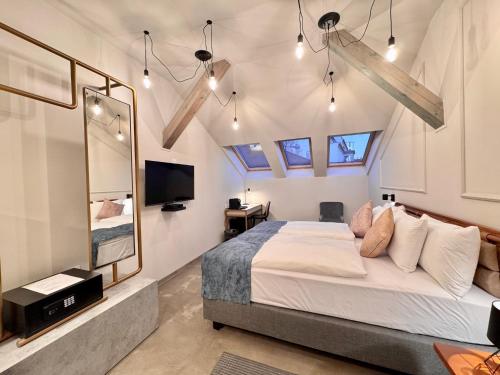 a bedroom with a bed and a tv and windows at Bazaar Boutique Residence in Budapest