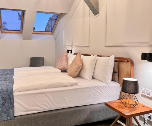 a bedroom with a bed and a table at Bazaar Boutique Residence in Budapest