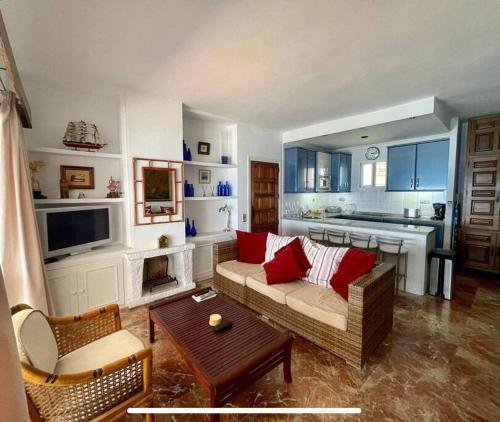 a living room with a couch and a table at Bungalow Calma La Roca 59 in Torremolinos