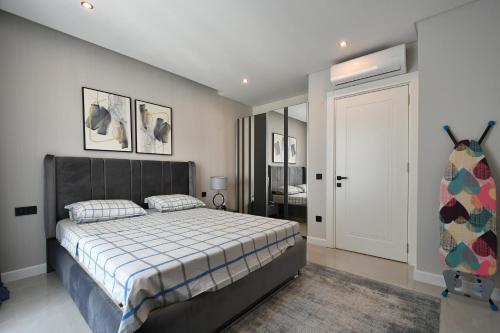 a bedroom with a large bed and a door at Litore 1 room 200 m sea in Alanya