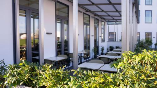 a row of tables and chairs on a building at A Hotels Glostrup in Glostrup