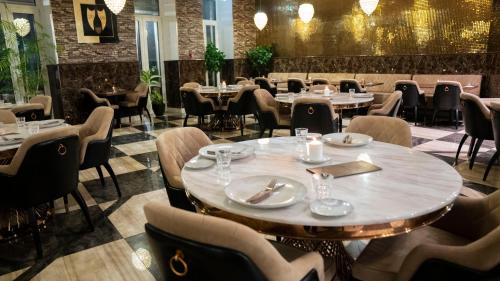 a restaurant with tables and chairs in a room at A Hotels Glostrup in Glostrup