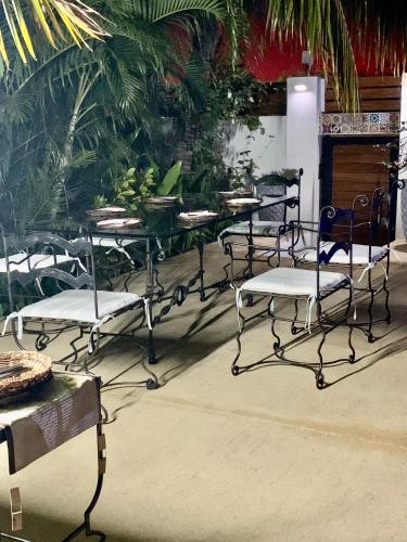 a group of chairs and tables with bananas on them at Jay&Kay CosyRoom FlicEnFlac in Flic-en-Flac