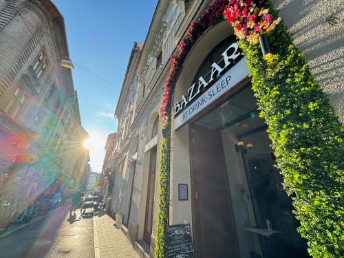 a building with a sign on the side of a street at Bazaar Boutique Residence in Budapest