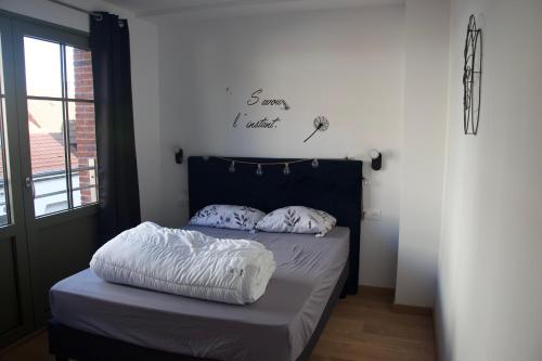 łóżko z 2 poduszkami w pokoju w obiekcie Apt 6 personnes terrasse vue parc w mieście Dunkierka