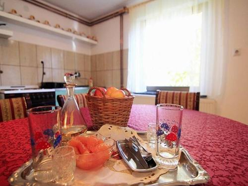 a table with a plate of fruit and glasses on it at Guest House 3M in Kaludjerske Bare