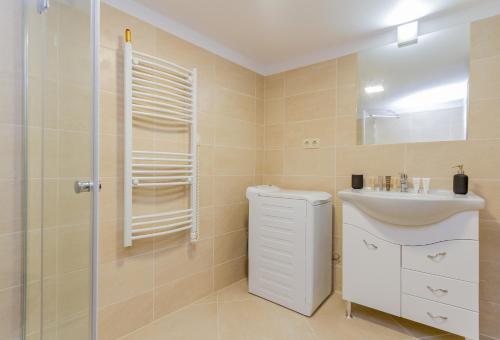 a bathroom with a toilet and a sink and a shower at Budapest Apartman Buda szívében in Budapest
