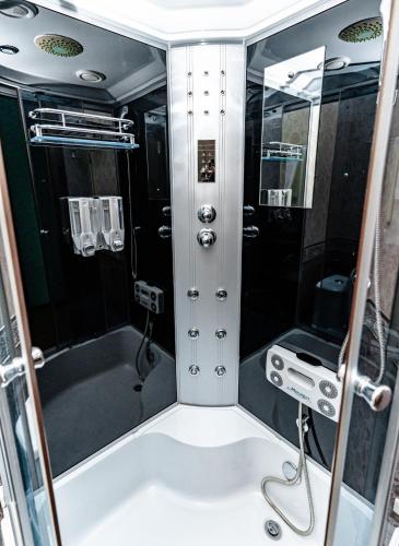 a small bathroom with a tub and a shower at Bagizagan Hotel in Samarkand