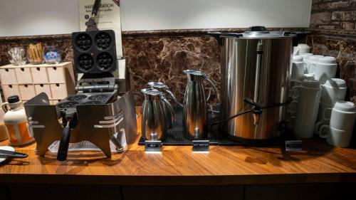 a counter with a coffee maker and bottles on it at A Hotels Glostrup in Glostrup