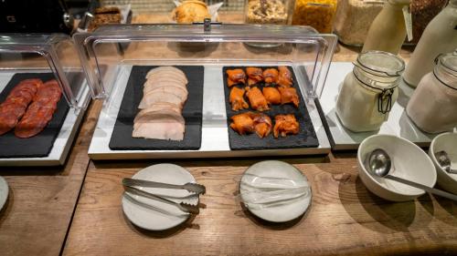a table with a tray of food with meat and skewers at A Hotels Glostrup in Glostrup