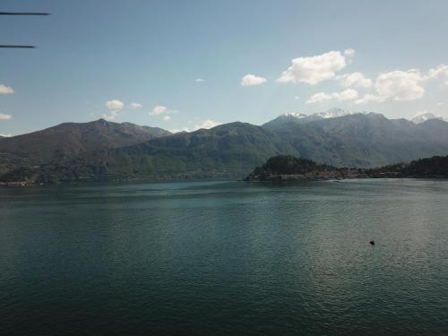 a large body of water with mountains in the background at Hotel Bazzoni in Tremezzo