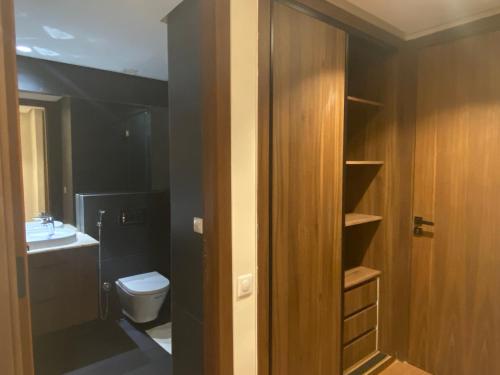 a bathroom with a toilet and a sink at Hilbert Princesses - Brand new furnished apartments in Casablanca