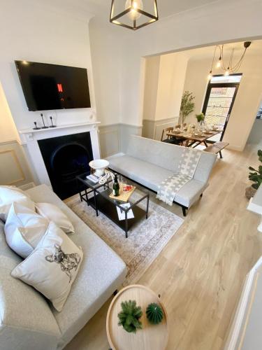 a living room with a couch and a fireplace at Carlton House in Northampton