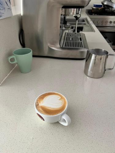 a cup of coffee sitting on a kitchen counter at Melbourne Balwyn north three bedroom house in Balwyn North