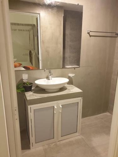 a bathroom with a white sink and a mirror at Lanka Villa Mirissa in Mirissa