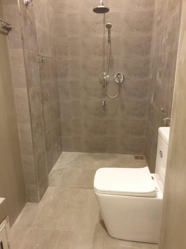 a bathroom with a shower with a toilet and a shower at Lanka Villa Mirissa in Mirissa
