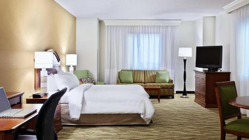 a hotel room with a bed and a desk at Spartanburg Marriott in Spartanburg