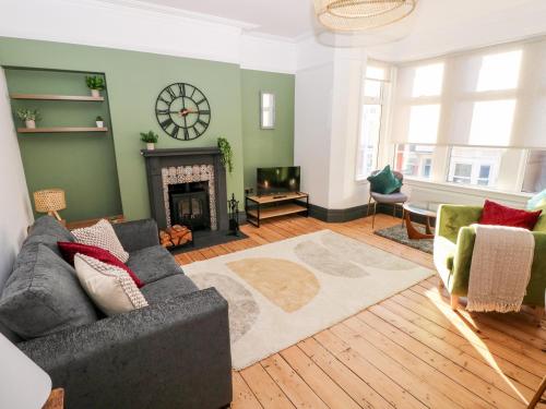 a living room with a couch and a fireplace at 36A Mary Street in Porthcawl