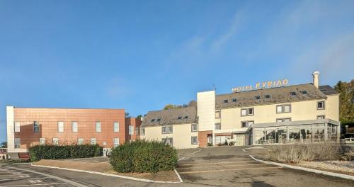 a building with a sign on the top of it at Kyriad Le Mans Est in Le Mans