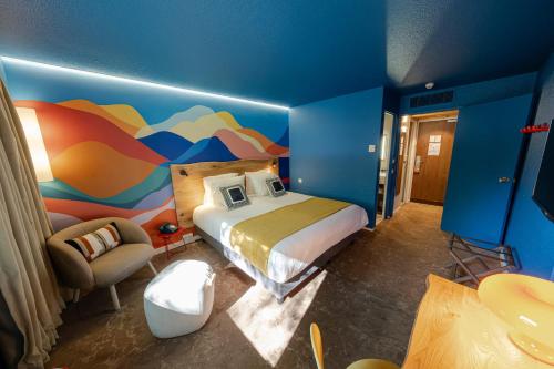 a bedroom with a bed and a colorful wall at Big Sky Hotel in Chamonix-Mont-Blanc