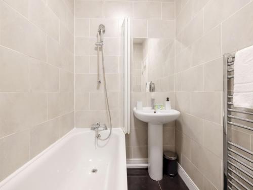 a white bathroom with a sink and a shower at Pass The Keys - Homely flat in east London with sunny Balcony in London