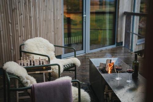 a room with a table and chairs and a chessboard at RewildThings Treehouses in Gloucester